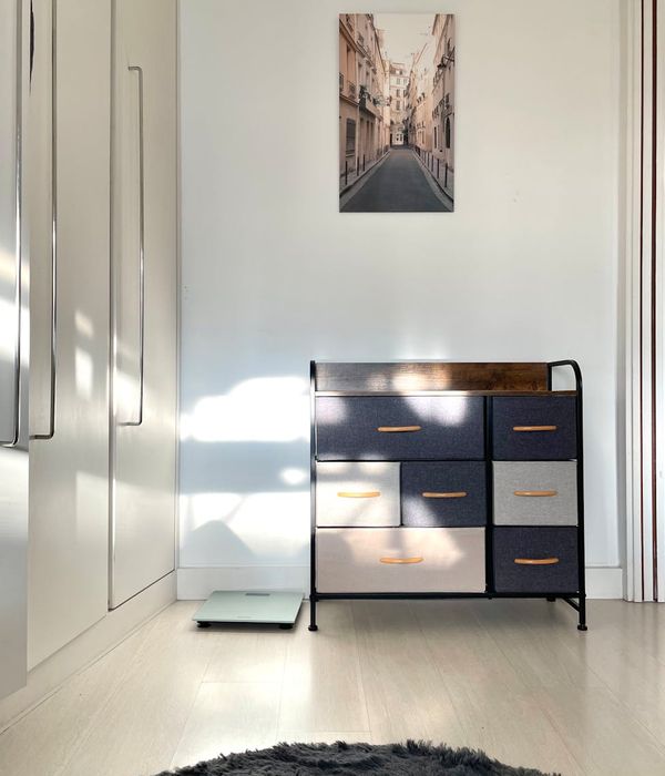 Modern minimalist bedroom with soft ambient lighting and neutral tones